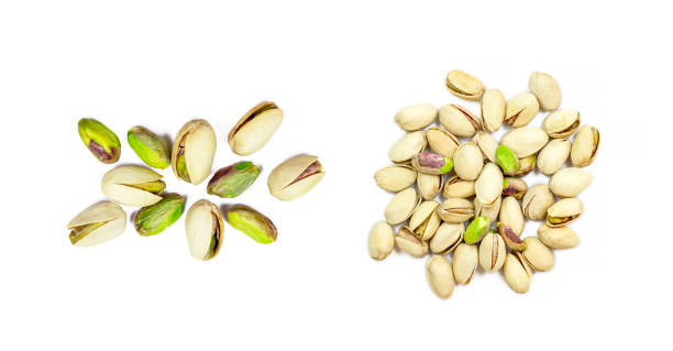 istock Top view of roasted salted pistachio nuts in nutshell set isolated on white background 1280052329