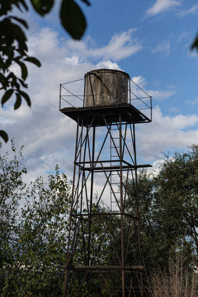istock Old tall water deposit on a rural scene on a blue cloudy sky 1280053447