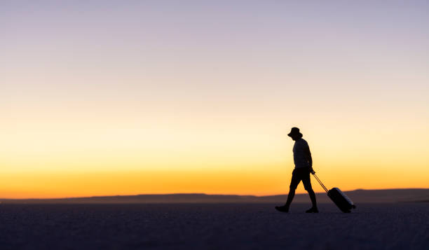 istock Man carries your luggage on salt lake 1280054572