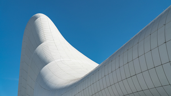 Baku, Azerbaijan - April 2018: Building exterior of Haydar Aliyev Centre which was designed by Zaha Hadid and is noted for its curvy, flowing architecture that avoids straight lines and sharp angles.