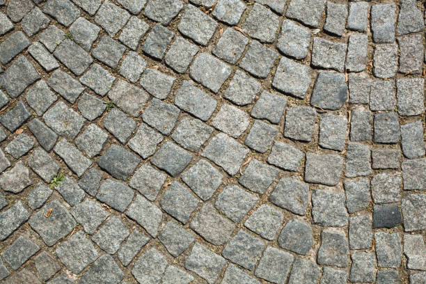 istock Stone pavement texture. Granite cobblestoned pavement background 1280060459