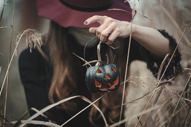istock Young beautiful enchantress walking in the forest, with a mask on 1280060840