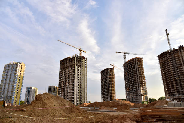 istock Tower cranes in action at construction site. Construction process of the new modern residential buildings 1280061653