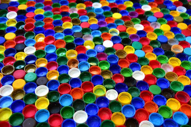 istock Plastic bottle caps background. Waste cap material is recyclable 1280061905