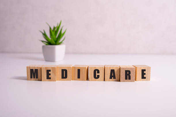 MEDICARE word made with building blocks, medical concept background. MEDICARE word made with building blocks, medical concept background medicare stock pictures, royalty-free photos & images