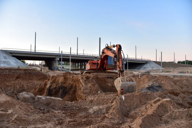istock Excavator during excavation at construction site. Backhoe on road work. Heavy Construction Equipment Machines for Earthworks. 1280063733