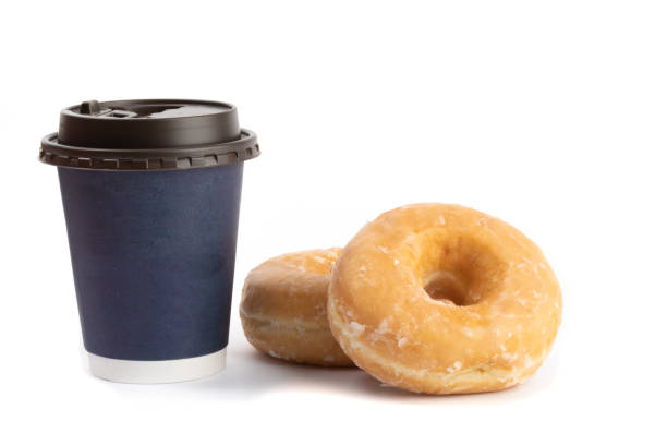 istock two honey glazed donuts beside a blue takeout coffee cup isolated on white 1280064984
