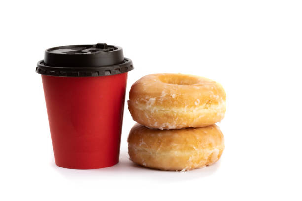 istock two honey glazed donuts stacked beside a red takeout coffee cup isolated on white 1280065568