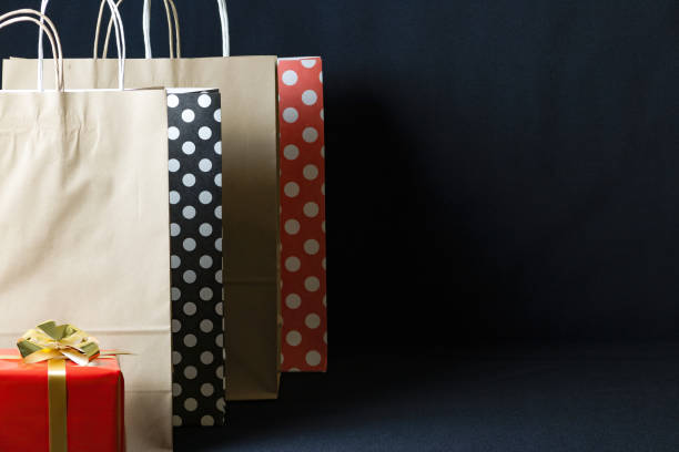 istock Black Friday sale concept. Gift boxes with gold ribbon on black background 1280065893