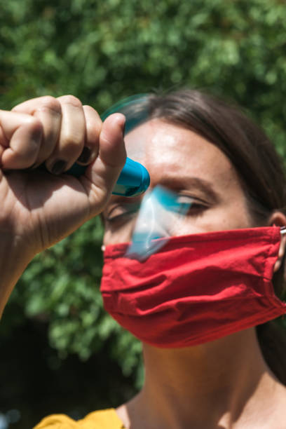 istock young woman cooling down with hand held ventilator while wearing a protective face mask 1280066678