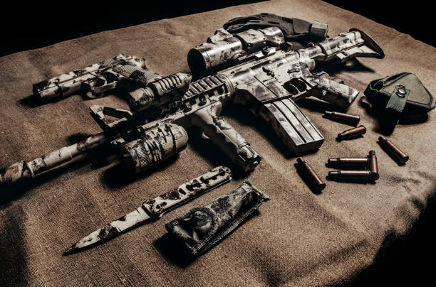 istock Camouflaged military AR-15 rifle. 1280069703