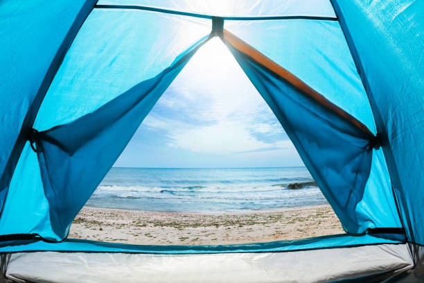istock Sunny day sea shore camping tent. 1280069808