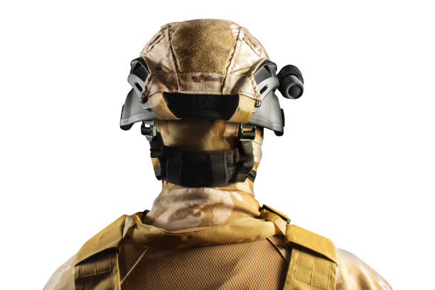 Soldier in desert olive uniform standing in helmet.