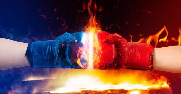 istock Red and blue boxing gloves punching with fire. 1280069855
