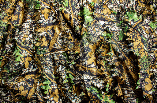 Photo of a hunting forest camouflage textured cloth.