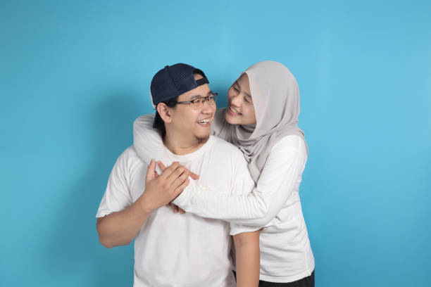 Happy Asian Muslim Couple Portrait of happy Asian muslim couple smiling, husband and wife hugging full of love, family concept happy malay couple stock pictures, royalty-free photos & images