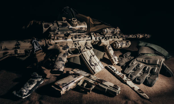 istock Military camouflaged military rifle laying on table. 1280071487