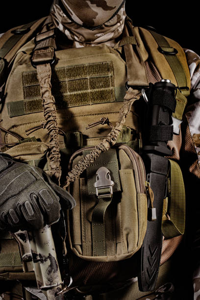 istock Soldier in uniform, armor and mask standing on black background. 1280071787