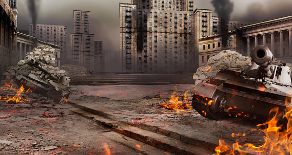Photo of a city war battlefield background with burning tanks and destructed buildings.