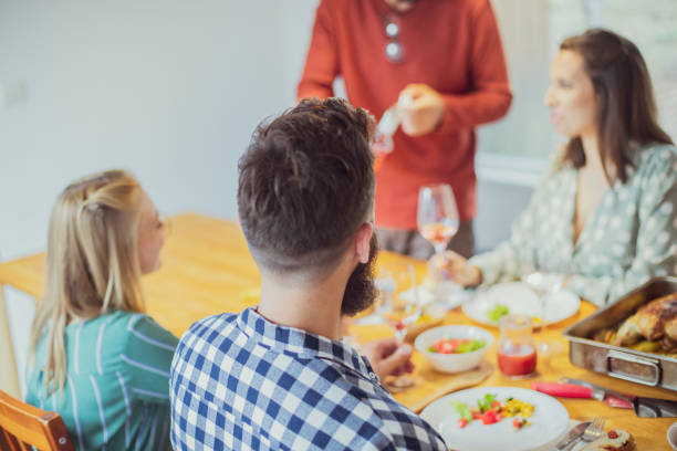 We don't need a house to be at home An image depicting two couples having fun meeting after a long time over lunch. They prepared turkey as main dish and they're drinking some wine as well. dont eat meat stock pictures, royalty-free photos & images