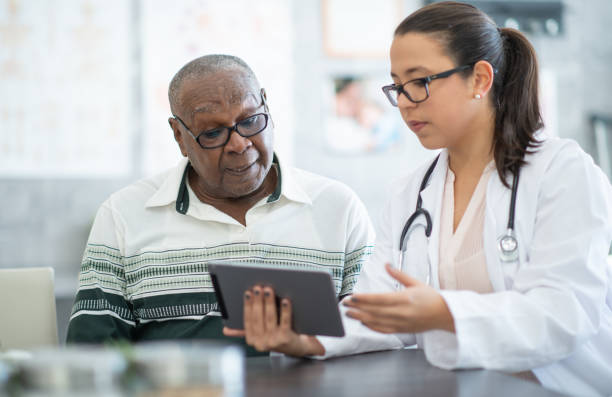 istock Senior consulting with doctor 1280077052