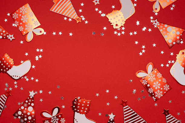 istock Christmas gifts presents on red background. Simple, classic red and white wrapped gift boxes with ribbon bows and festive holiday decorations. Horizontal bottom border. 1280077070
