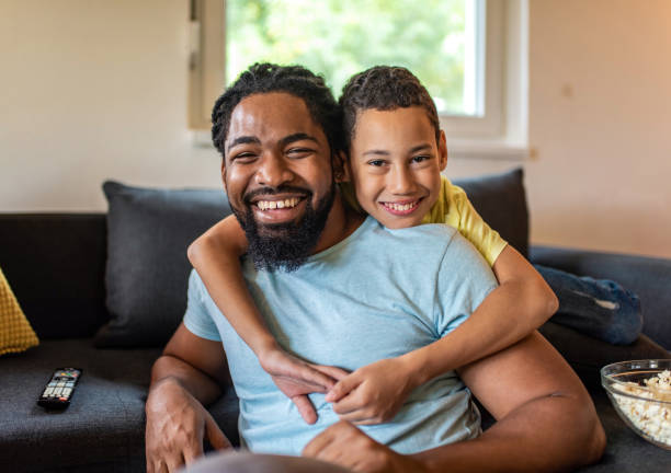 istock Playful African American man relaxing at home with his son. 1280077830
