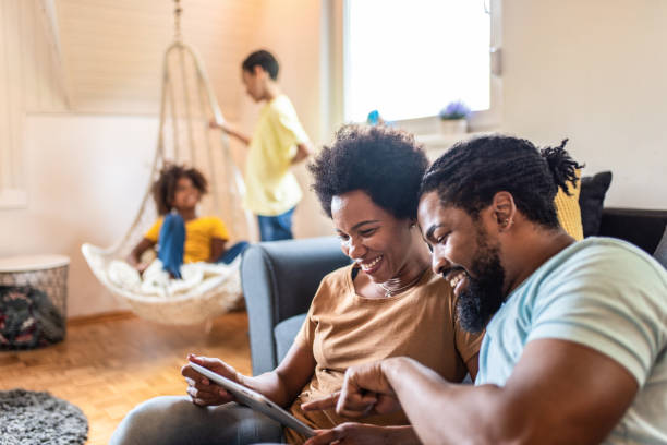istock Happy African American parents using digital tablet. 1280078485