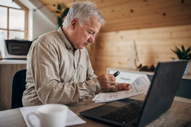 istock One senior man reading a document with the help of a magnifying glass at home 1280081338