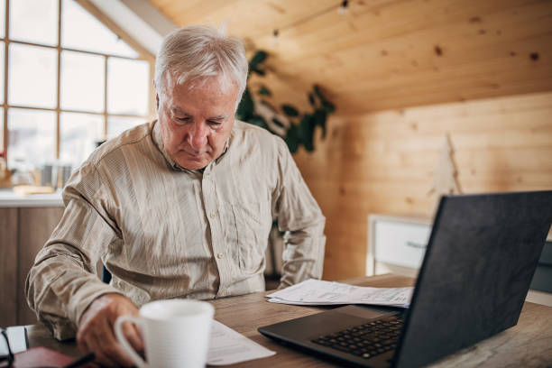 istock One senior businessman doing some paperwork at home 1280081464