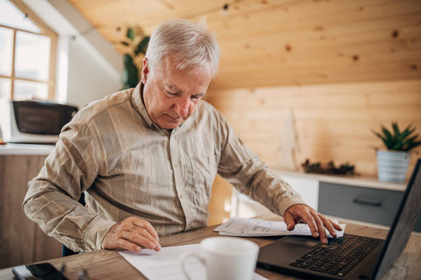 istock Senior man going through some paperwork at home 1280081565
