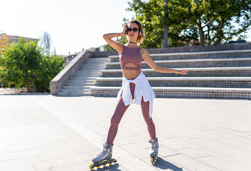 Girls learning roller skating and skateboarding in public park
