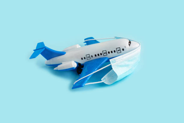 istock Airplane Model with Protective face medical mask 1280083310