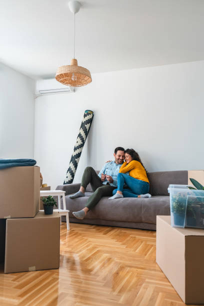 istock Happy couple embracing on sofa stock photo 1280084295