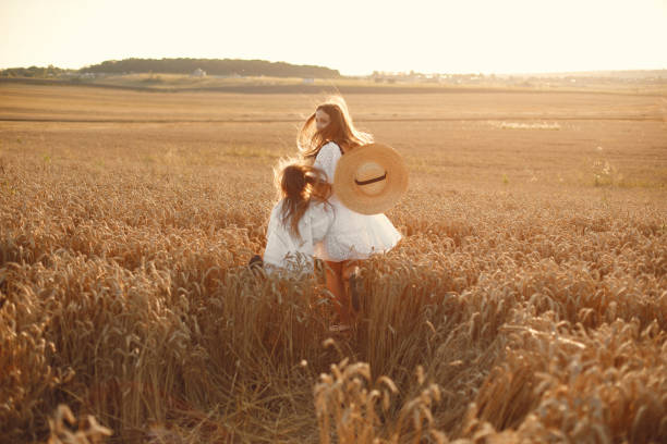 istock Mother with daughter in a wheat field 1280085973
