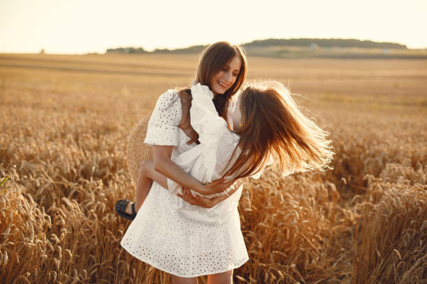 istock Mother with daughter in a wheat field 1280086009