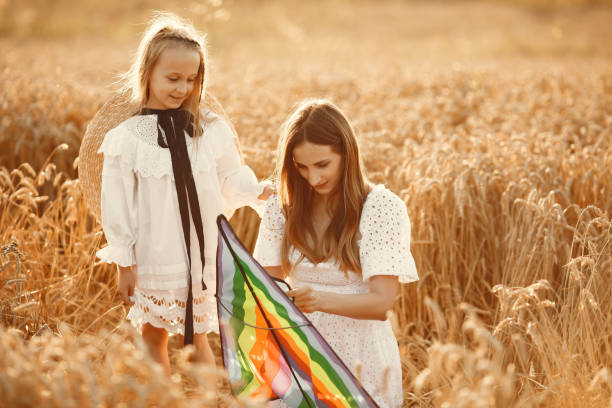 istock Mother with daughter in a wheat field 1280086068