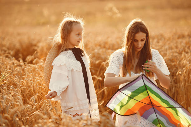 istock Mother with daughter in a wheat field 1280086070