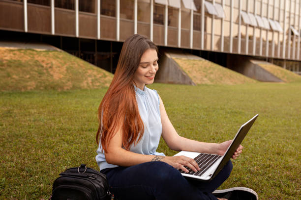 istock Young woman studying with laptop on campus outdoor 1280086971