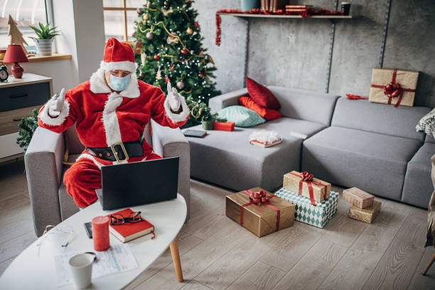 istock Santa Claus with protective face mask having video conference call with children 1280087697