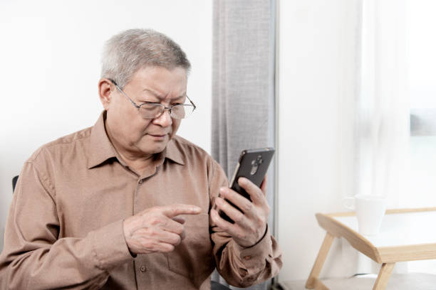 istock Old people looking at cell phone 1280091166