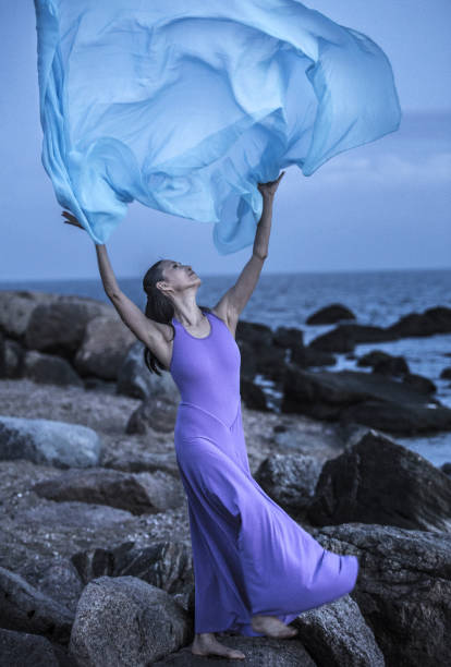 istock Woman dancing in moonlight on a rocky beach in Connecticut. 1280093354