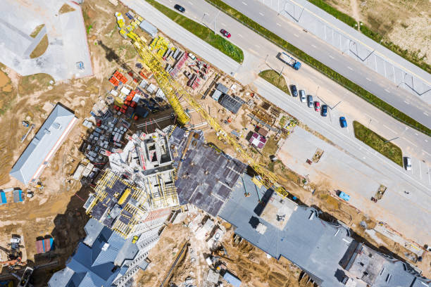 istock busy construction site. crane, construction materials and machinery. aerial drone photo looking down 1280093519
