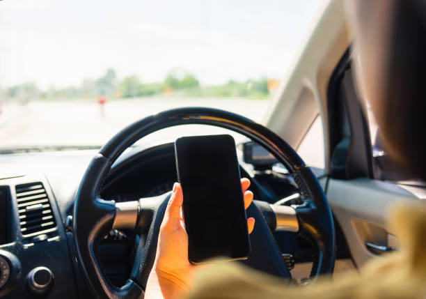 istock woman inside a car and using a hand holding mobile smartphone 1280095803