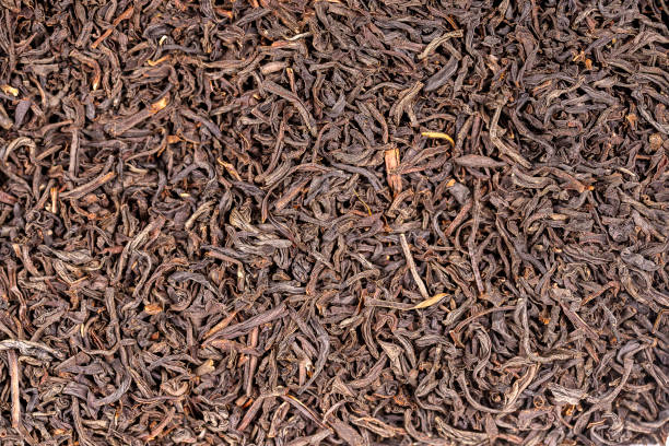 istock Black tea leaves background. Abstract food textures. Close up 1280095931
