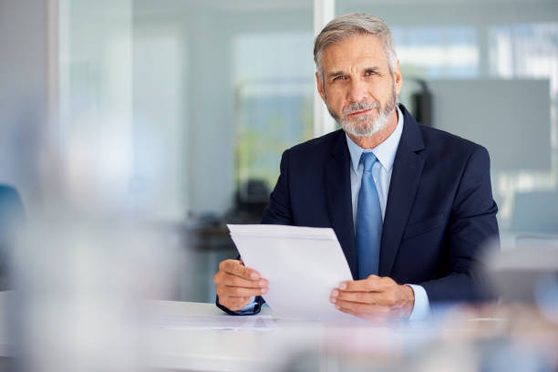 istock Portrait of businessman holding documents 1280097846