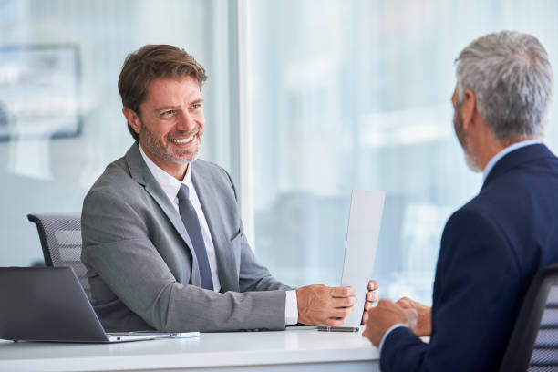 istock Businessmen discussing in office 1280097889
