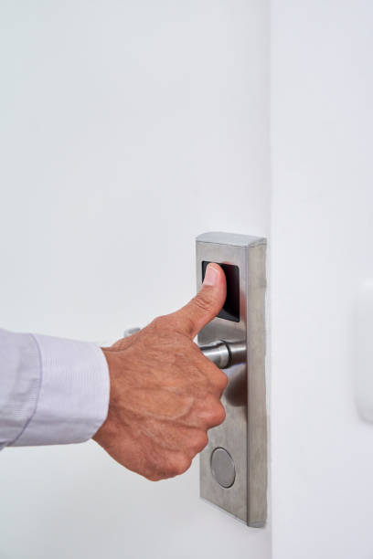 istock Man placing thumb on fingerprint-reading door lock 1280098637
