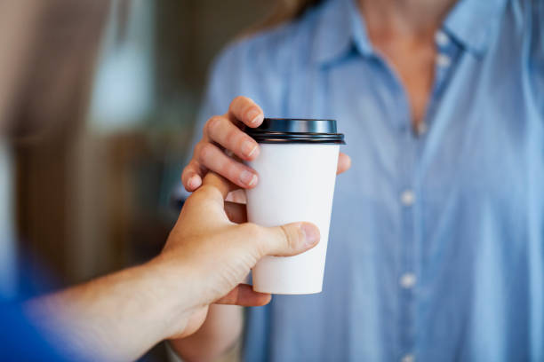 istock Woman holding disposable cup 1280098801