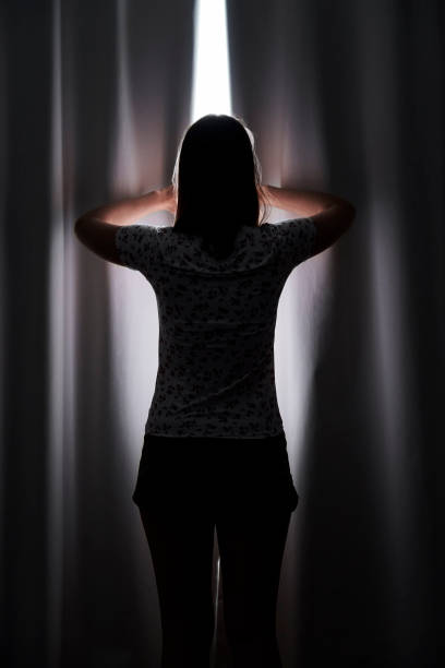 istock Woman drawing curtains at home 1280098979